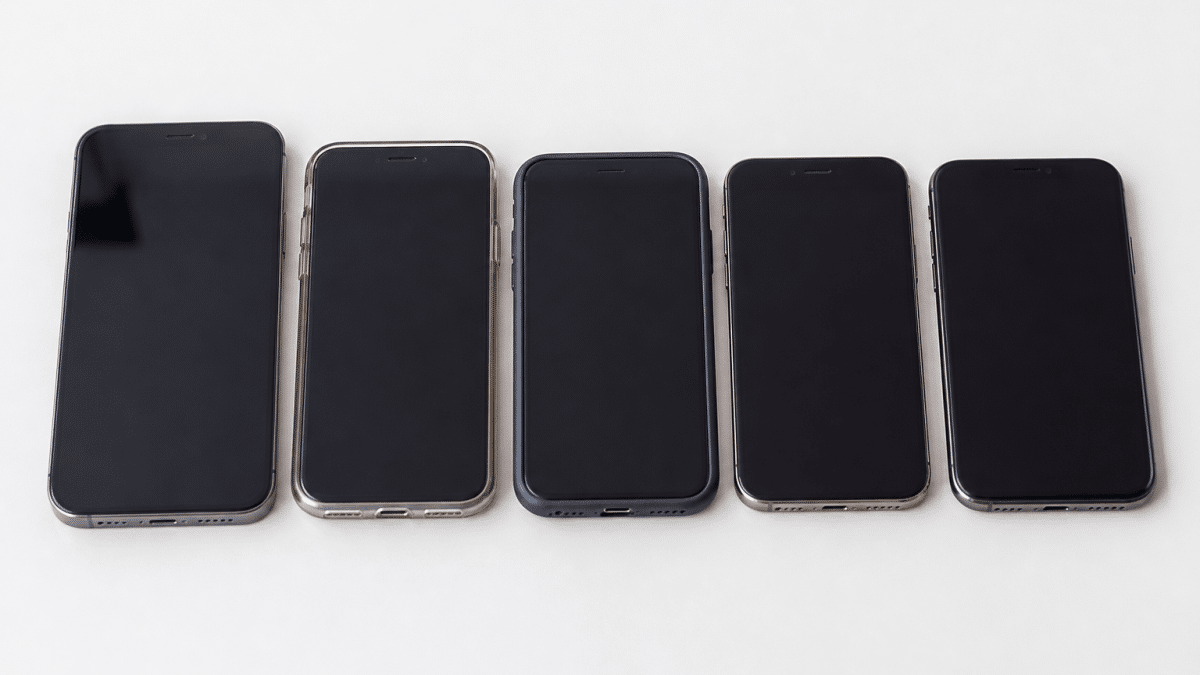 Plusieurs telephones modernes alignes cote a cote sur fond blanc